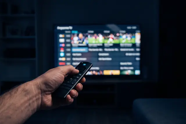 Remote control choosing a live sports IPTV channel in the MIPTV4K guide
